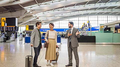 Couple being greeted by third party host from Diamond Air, in Heathrow Terminal 5.