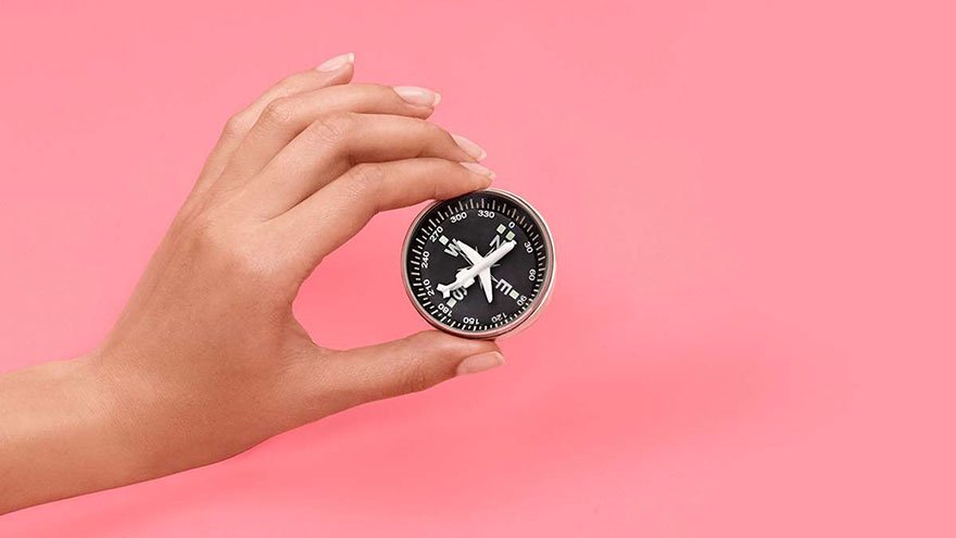 Compass held in woman's hand.