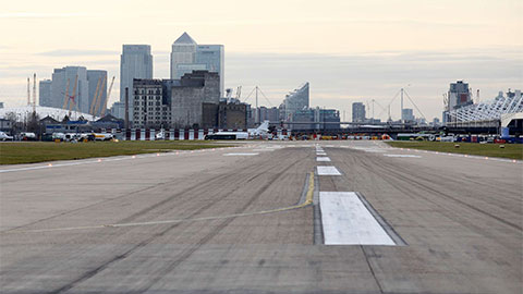 Runway at London City with the London skyscrapers in the background.
