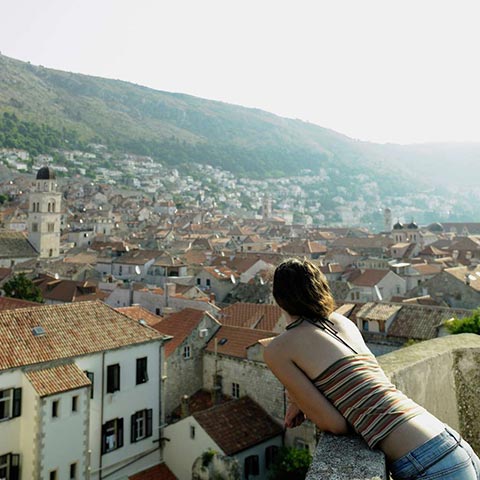 Young woman overlooking Dubrovnik, Croatia.