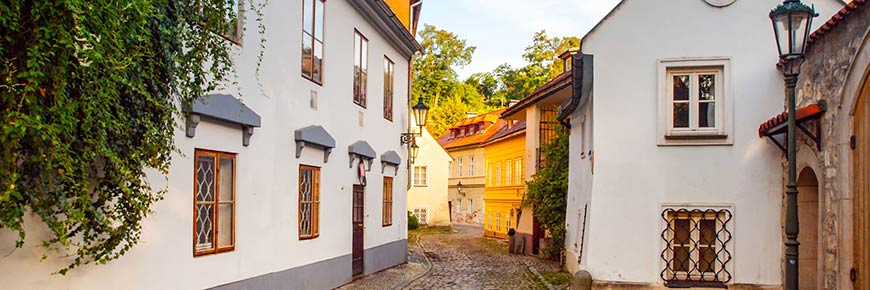 Old medieval narrow cobbled street and small ancient houses of novy svet, hradcany district, prague, czech republic.