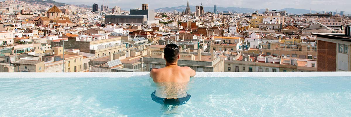 Man overlooking Barcelona in pool.