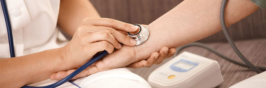 Close-up of nurse measuring someone's blood pressure.