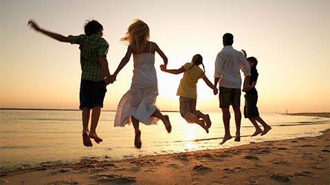 Family jumping on a beach.