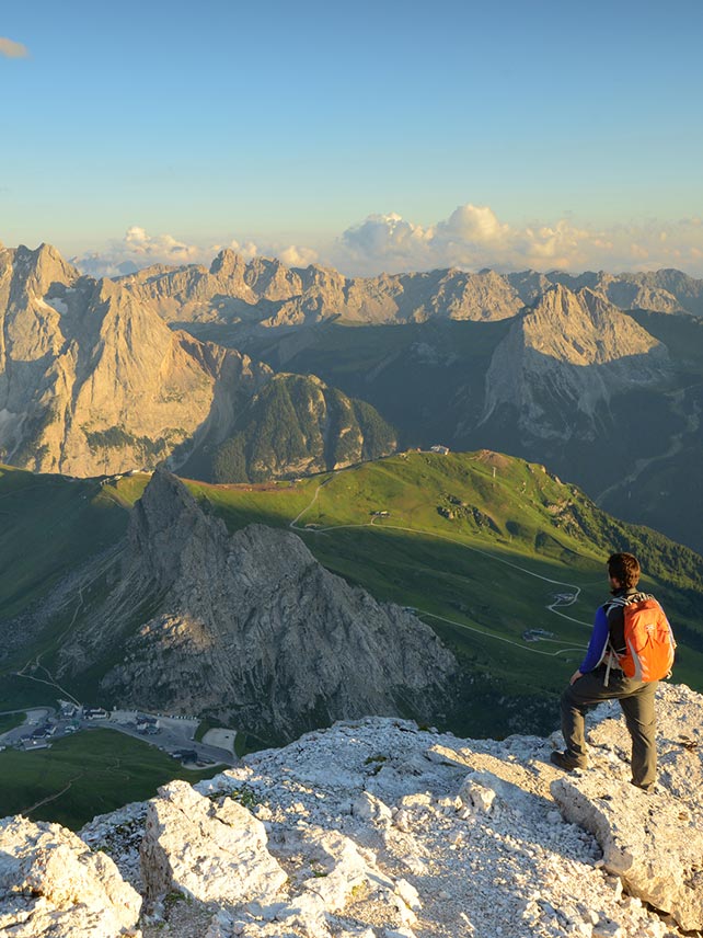 Man standing on top of Sass Pordoi, South Tyrol, Italy. ©Maya Karkalicheva.