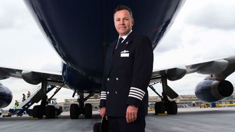 Captain Steve Allright standing under an aircraft.